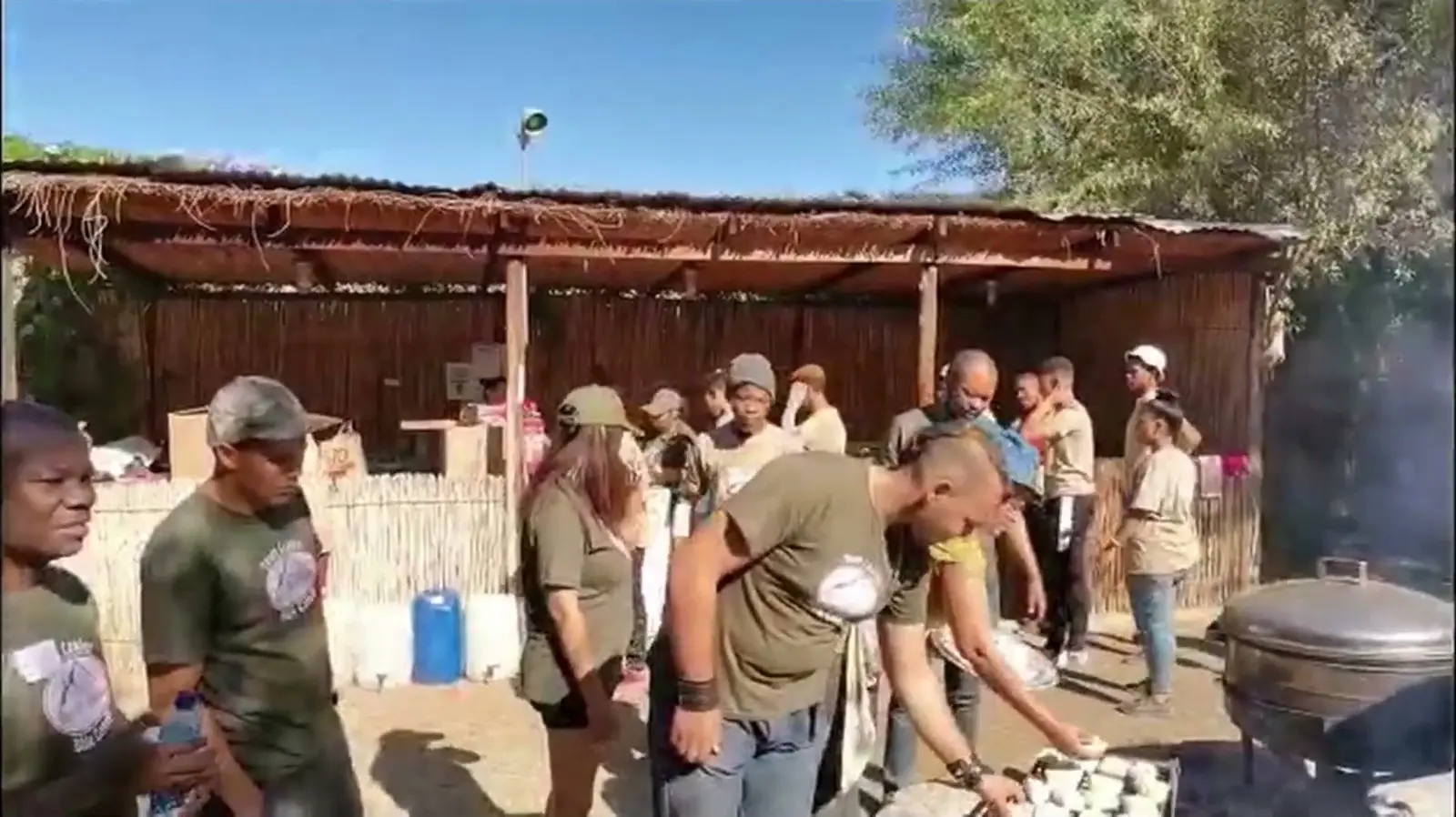 Camp team preparing a meal outdoors
