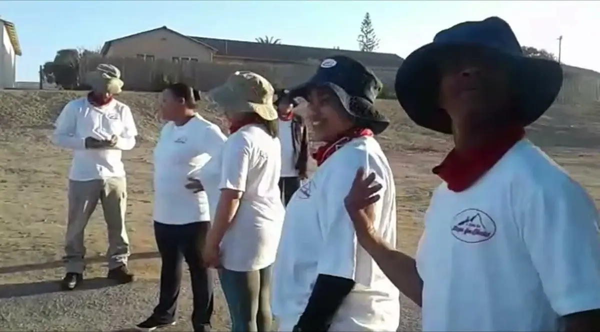 An early Steps for Christ hiking team in white shirts and red scarves