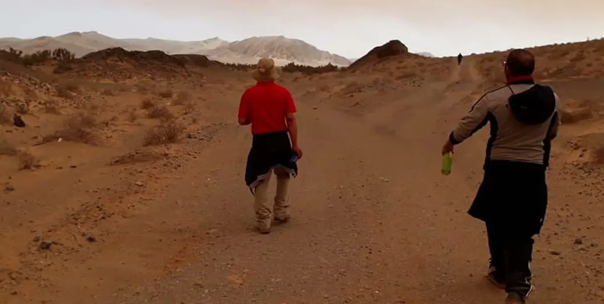 Hikers walking through red desert dust in the Richtersveld