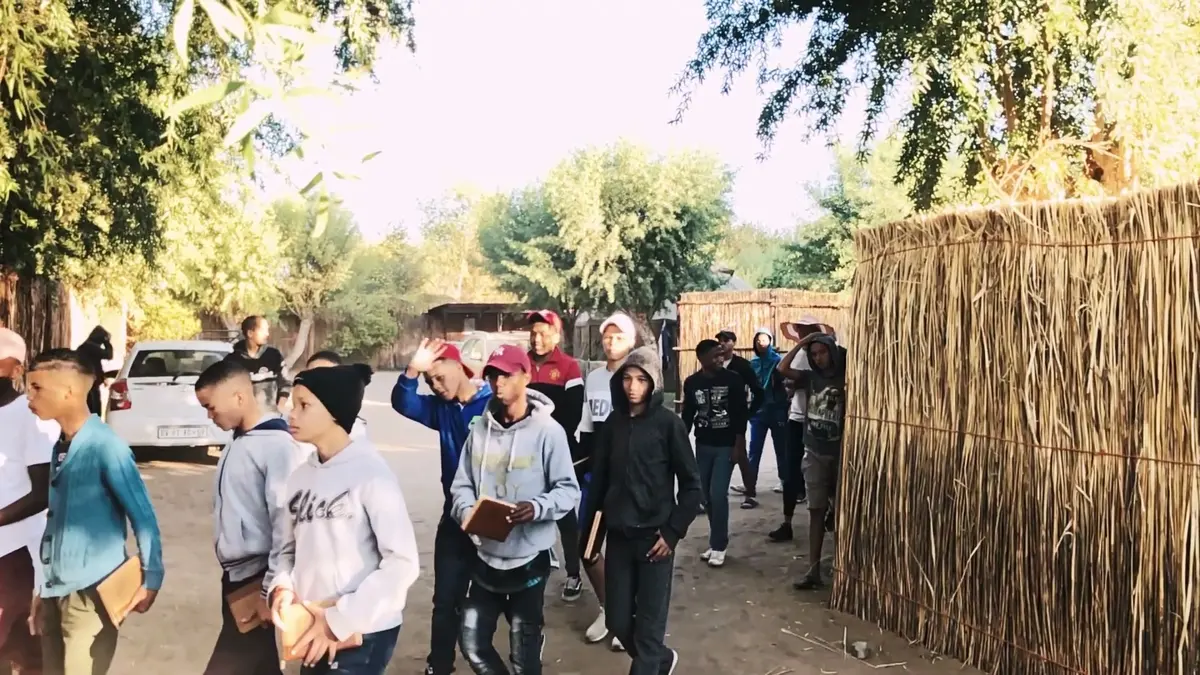 Boys arriving at the first Bible camp carrying their Bibles